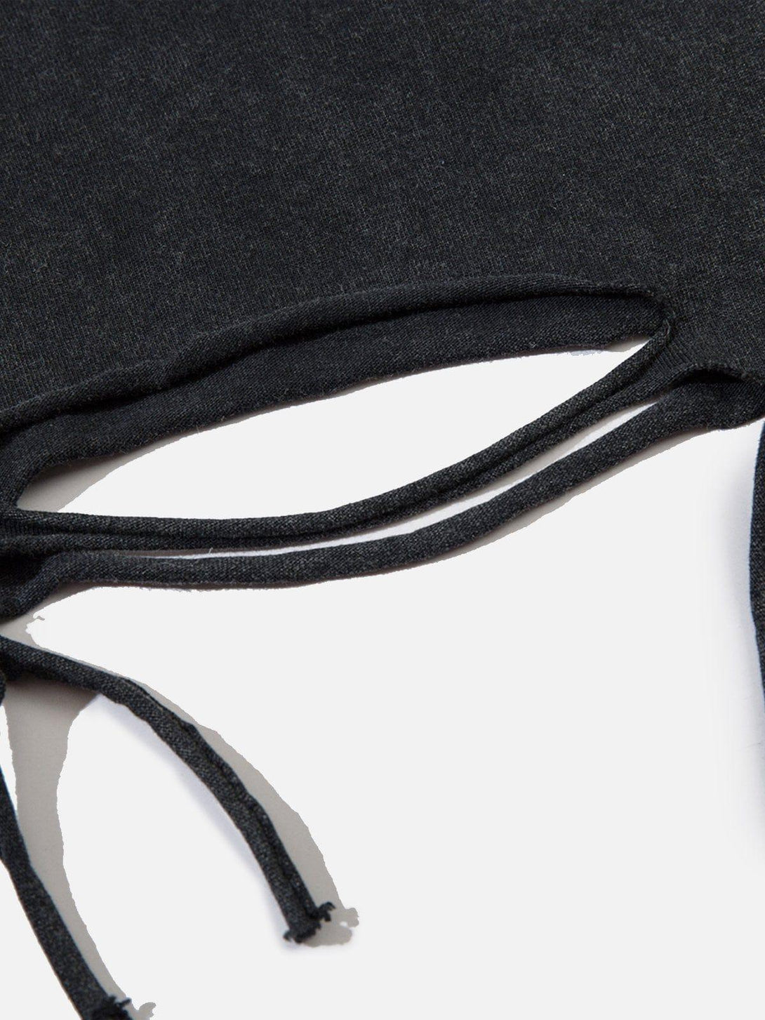 A tight crop highlighting the cutout details on a washed black tee by TALISHKO.