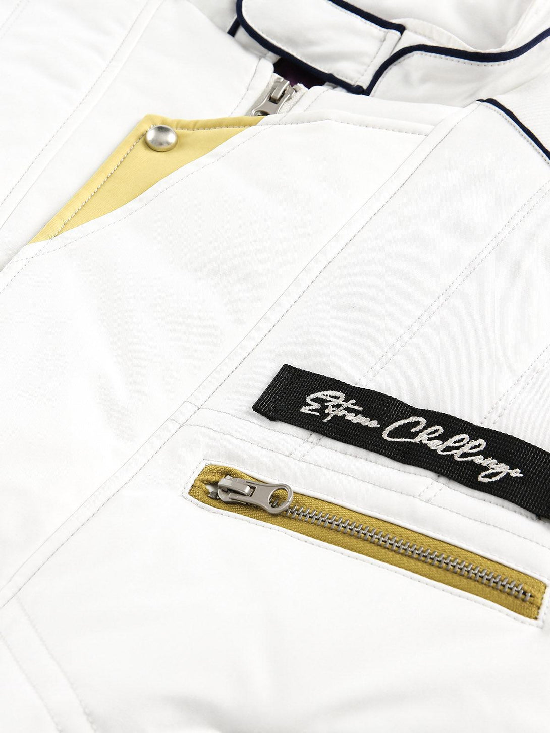 Intricate look at the TALISHKO jacket's embroidered logo and zipper detail.