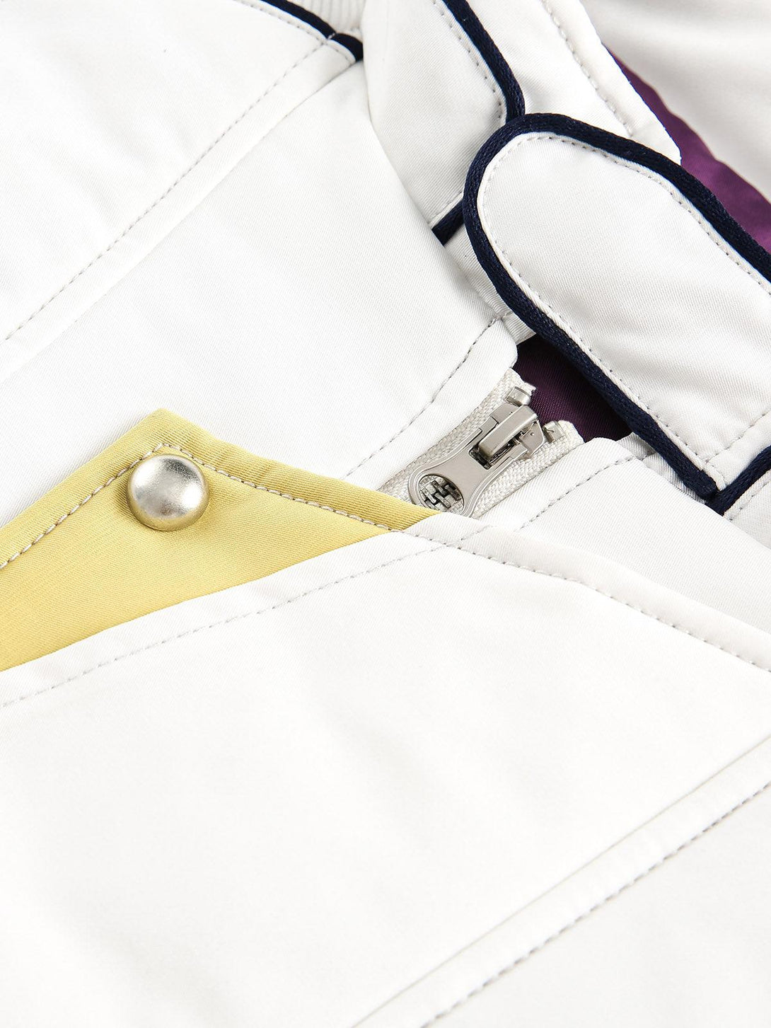 Focusing on the TALISHKO jacket's intricate stitching and metallic accents for a stylish touch.