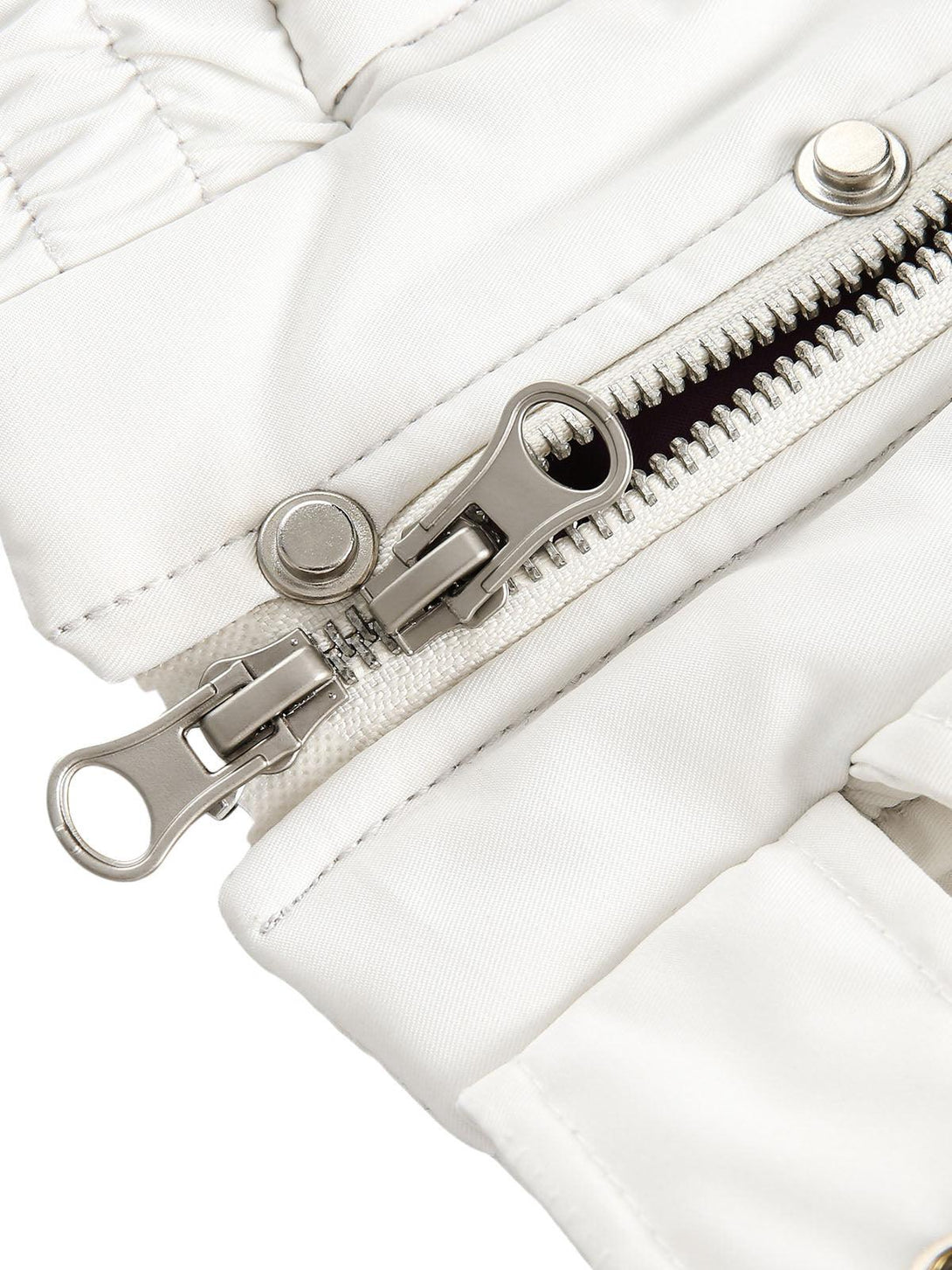 A detailed view of the TALISHKO bomber jacket's dual zipper and metal snap accents.