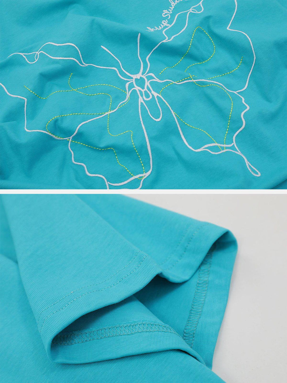 Intricate look at a blue TALISHKO tee's embroidery, highlighting butterfly line art design.