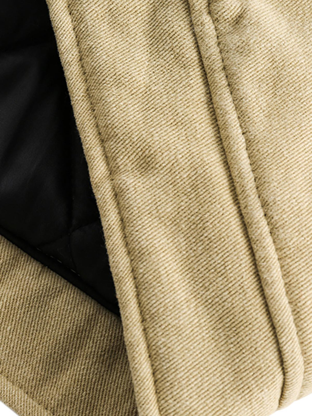 A detailed view of TALISHKO's quilted barn jacket, highlighting the textured fabric and stitching.