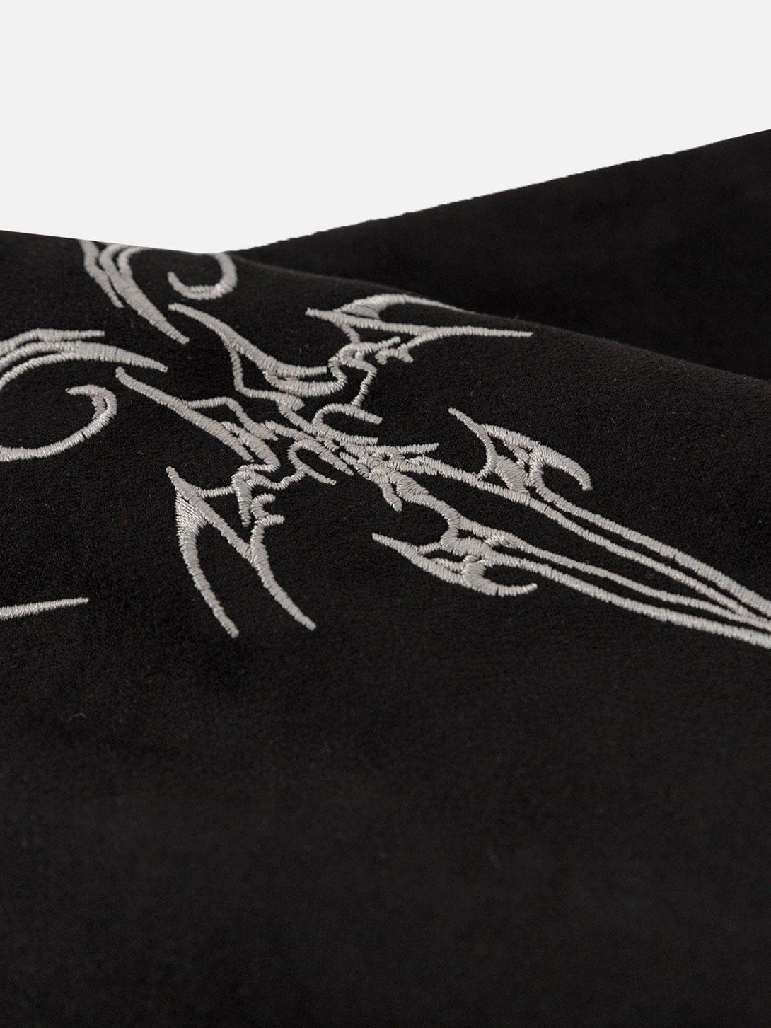 Intricate embroidery detail on a black suede tee by TALISHKO, showcasing unique craftsmanship.