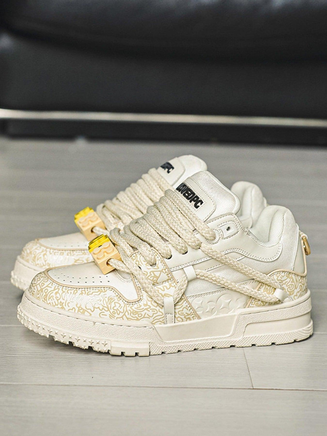 TALISHKO casual sneakers in cream with detailed patterns and thick laces, ideal for everyday wear.