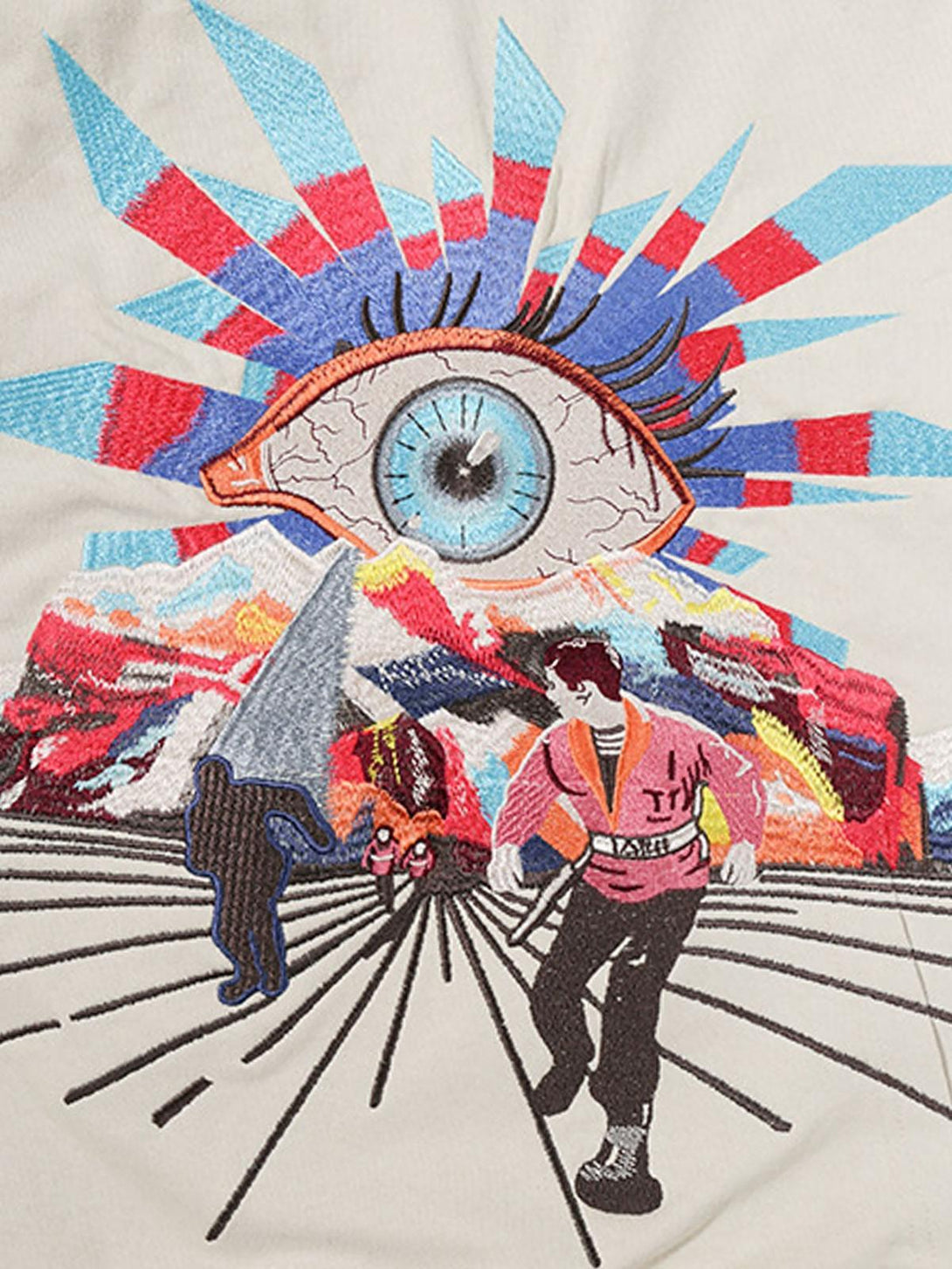 A detailed look at the vibrant evil eye embroidery on a TALISHKO hoodie, featuring artistic designs.