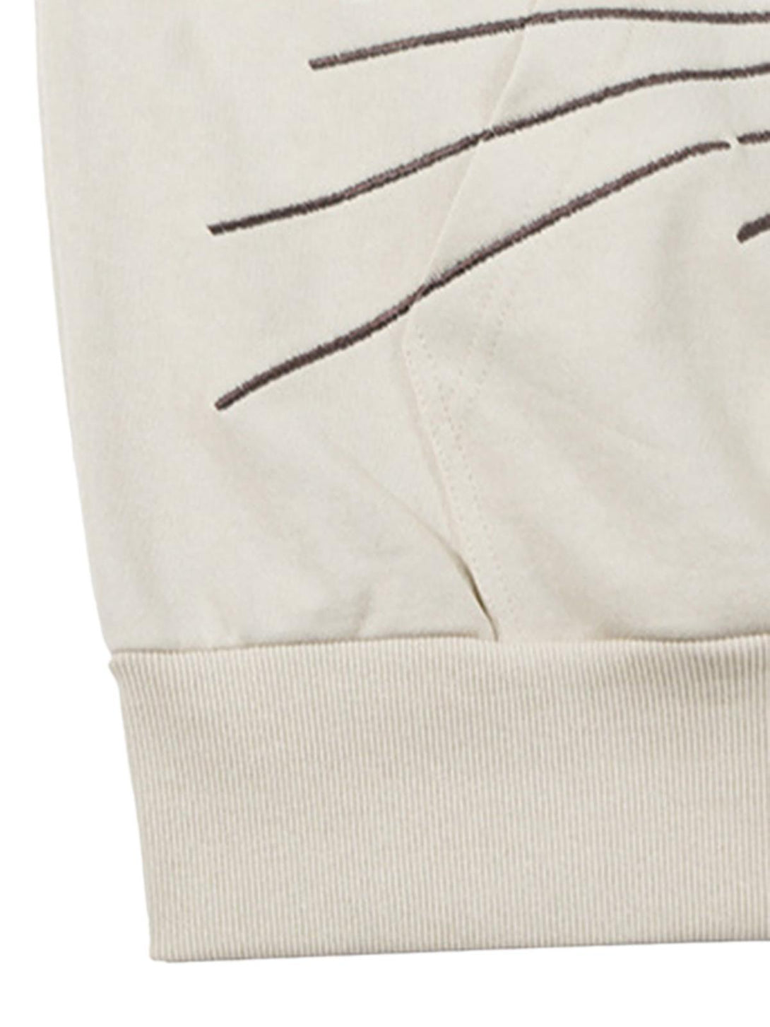 Detailed fabric and stitching of a TALISHKO hoodie, highlighting artistic embroidery lines.