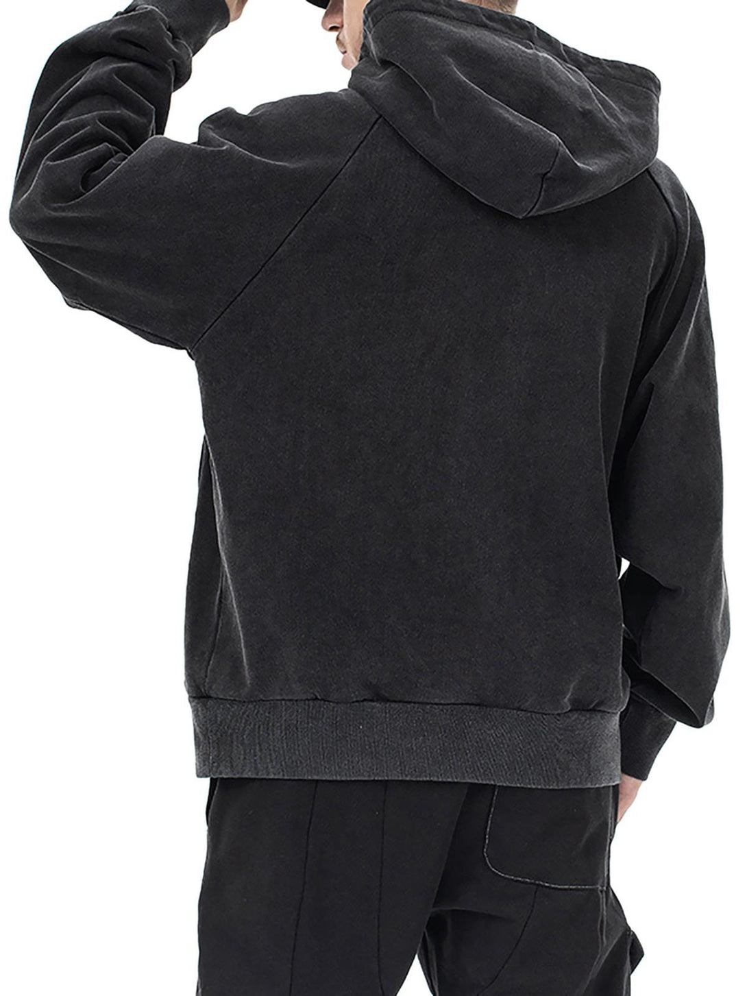 Model wearing a black TALISHKO hoodie, highlighting its relaxed fit and casual style.