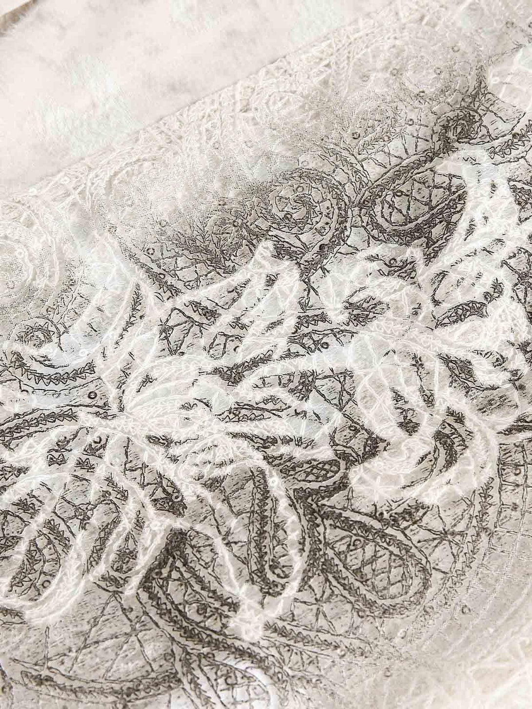 Intricate look at floral embroidery on TALISHKO's short-sleeve shirt, showcasing elegant detail.