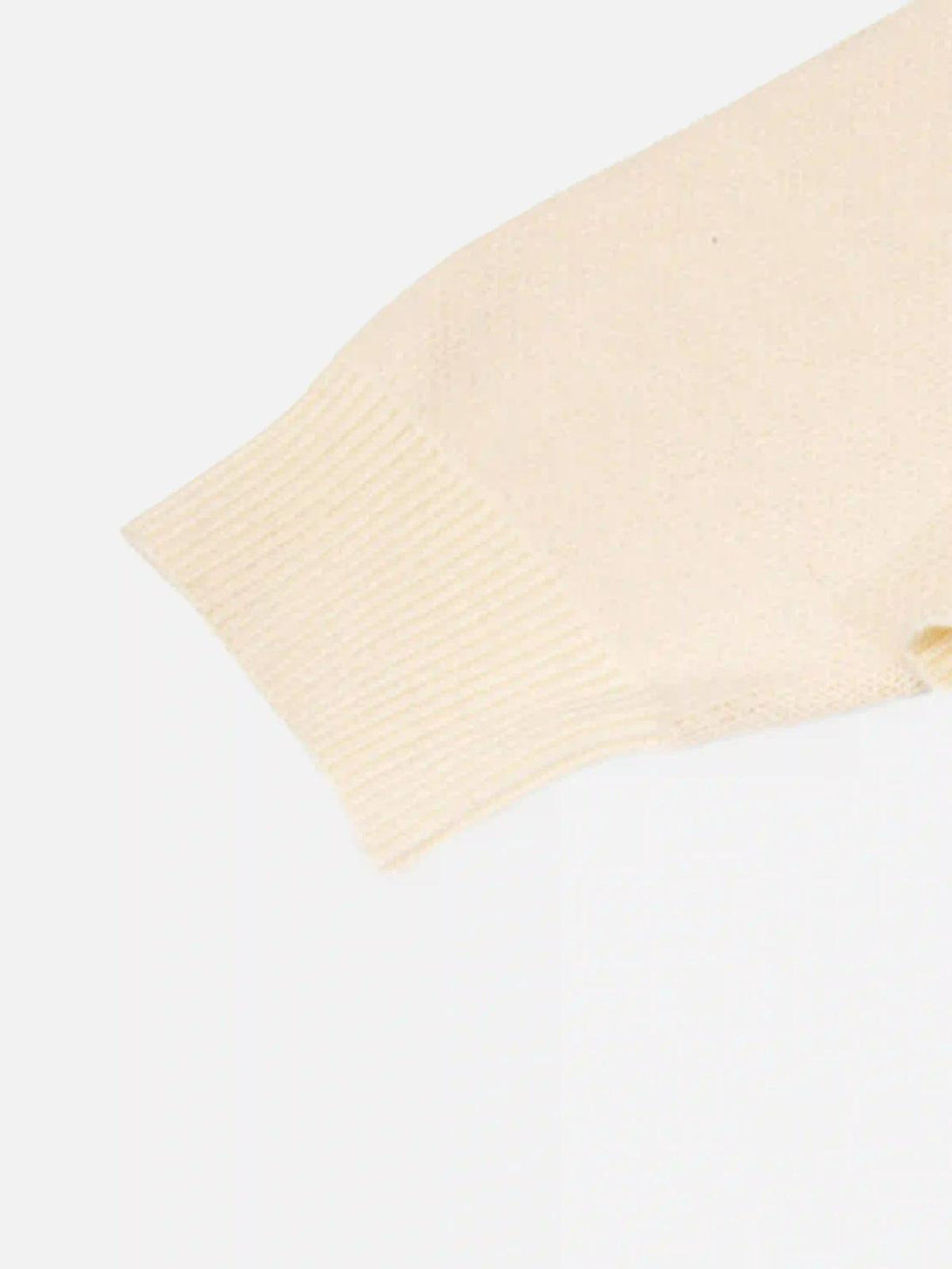 A tight crop highlighting the ribbed cuff detail on the Eye Contact Sweater by TALISHKO.
