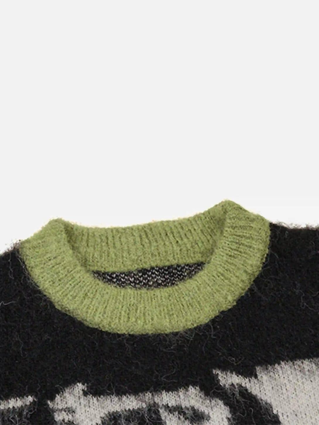 Focusing on the green collar detail of TALISHKO's mohair sweater with a bold facial pattern.