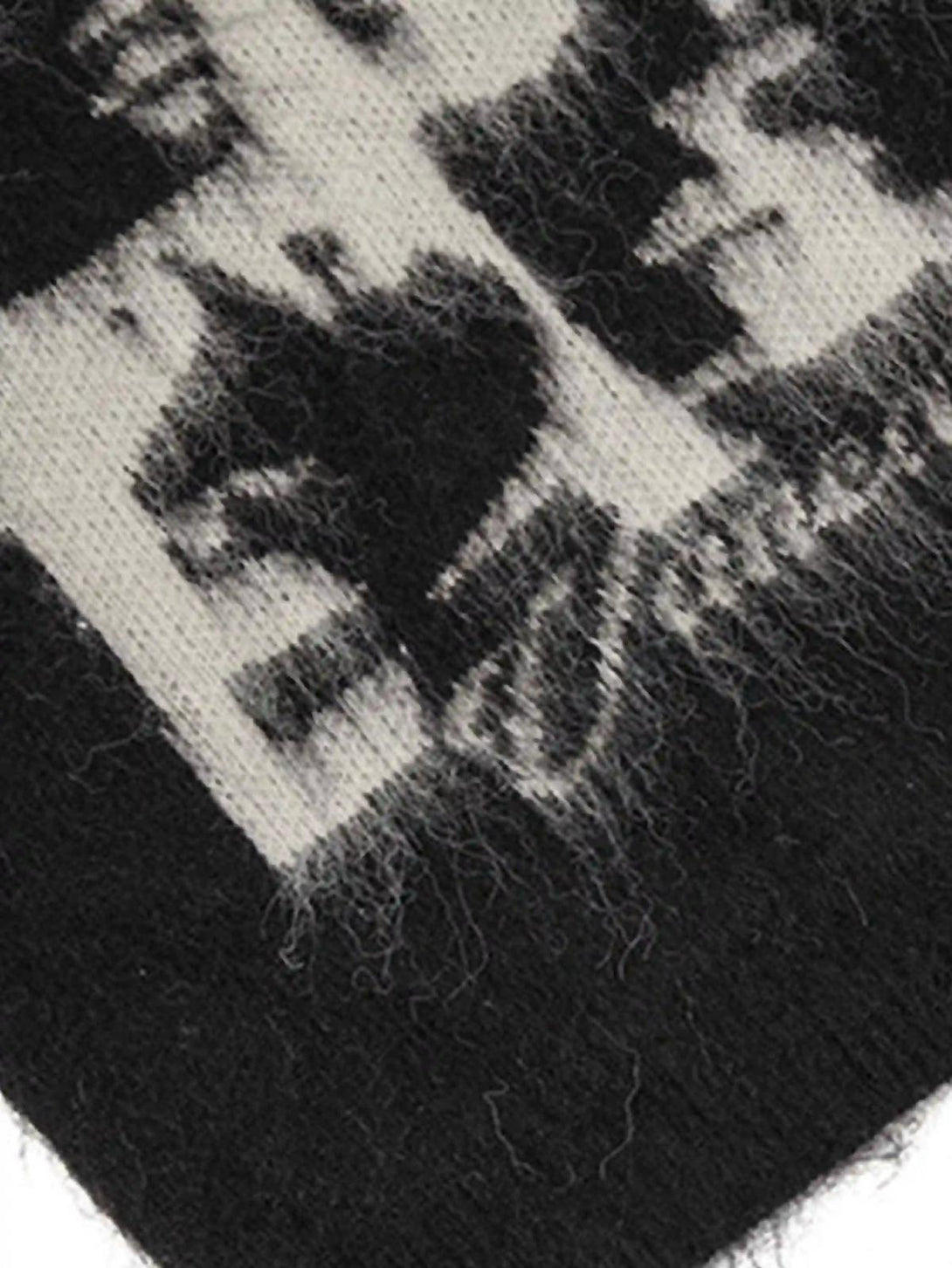 Intricate look at TALISHKO's mohair sweater with a black and white facial pattern detail.