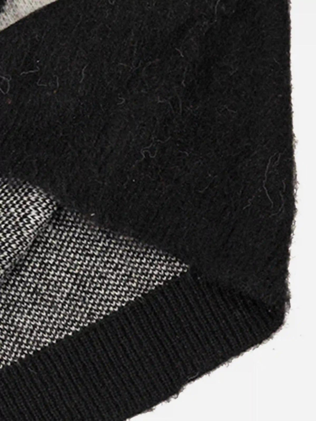 A close-up of TALISHKO mohair sweater's intricate black and white texture detail.