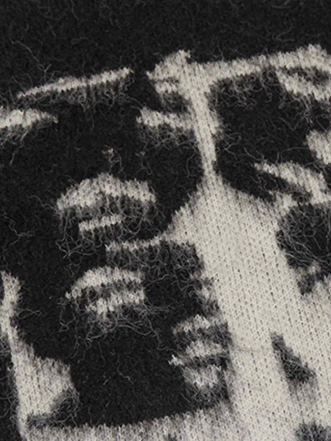 A tight crop highlighting TALISHKO's mohair sweater with intricate black and white facial pattern.
