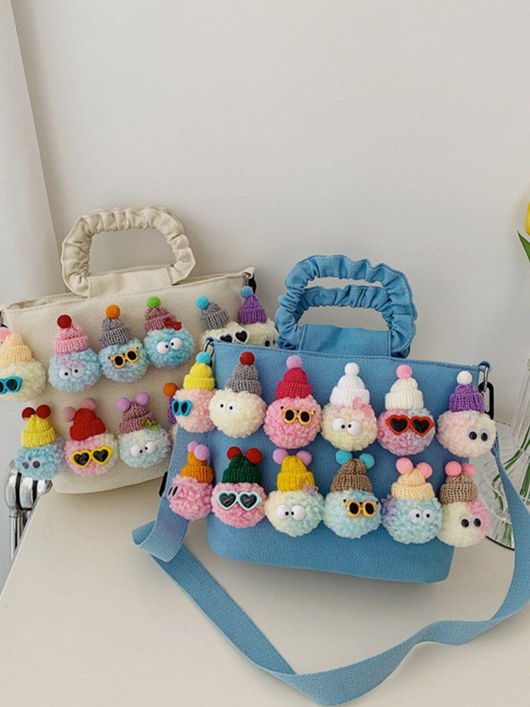 TALISHKO's canvas bags with colorful pom-pom characters in a whimsical design.