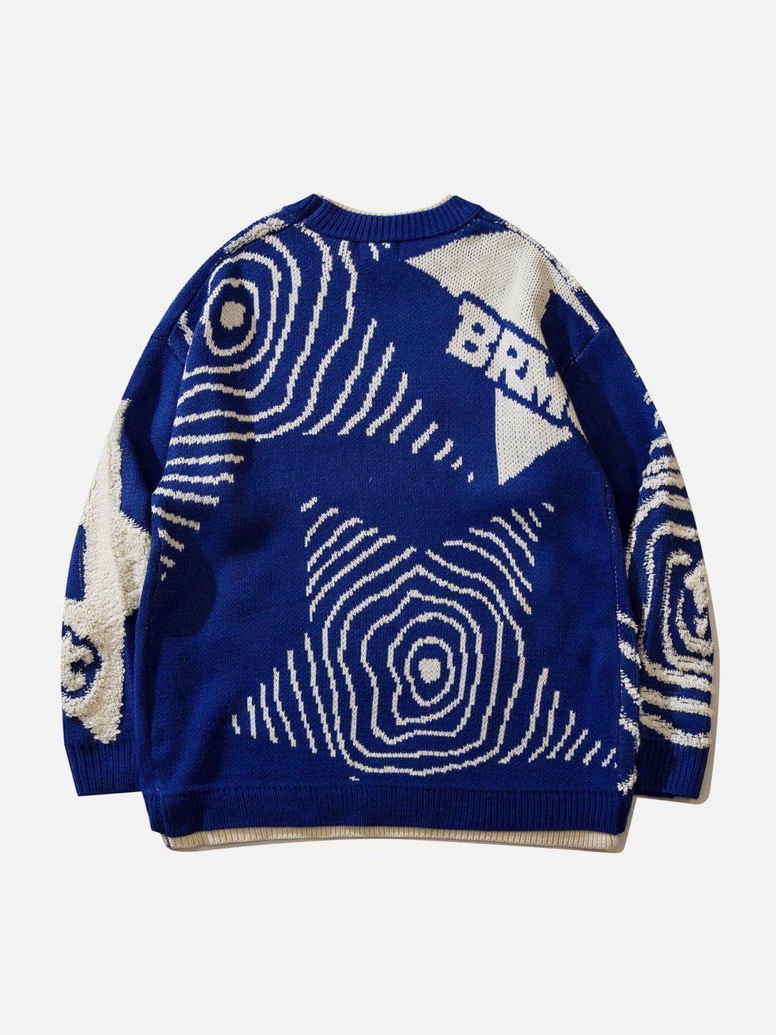 Back view of TALISHKO's blue sweater featuring an abstract patchwork design with white accents.