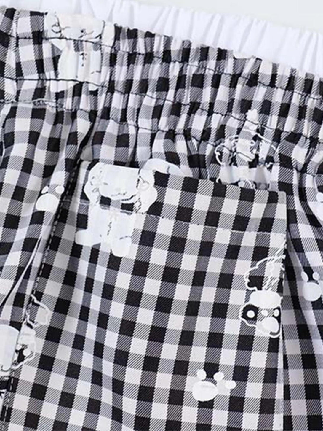 Detailed fabric and print of TALISHKO plaid sweatpants, highlighting elastic waistband design.