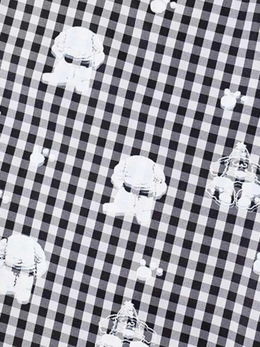 TALISHKO sweatpants feature a checkered plaid pattern with whimsical print details.