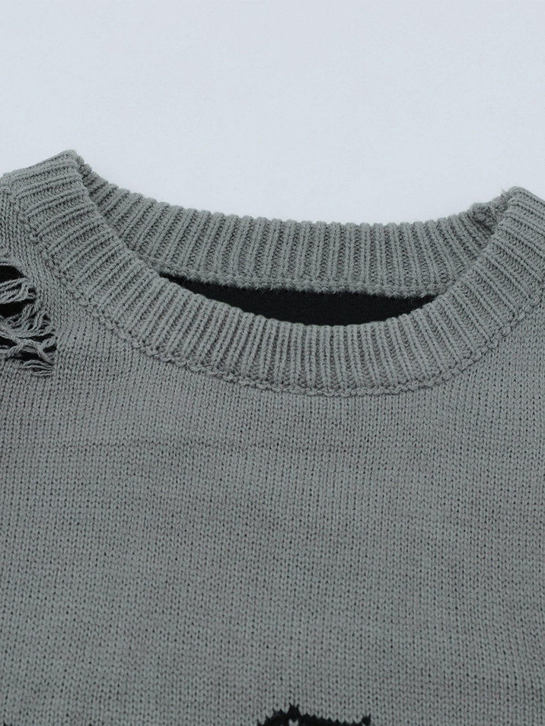 Detailed view of the TALISHKO sweater's neckline, showcasing its unique knit texture and style.