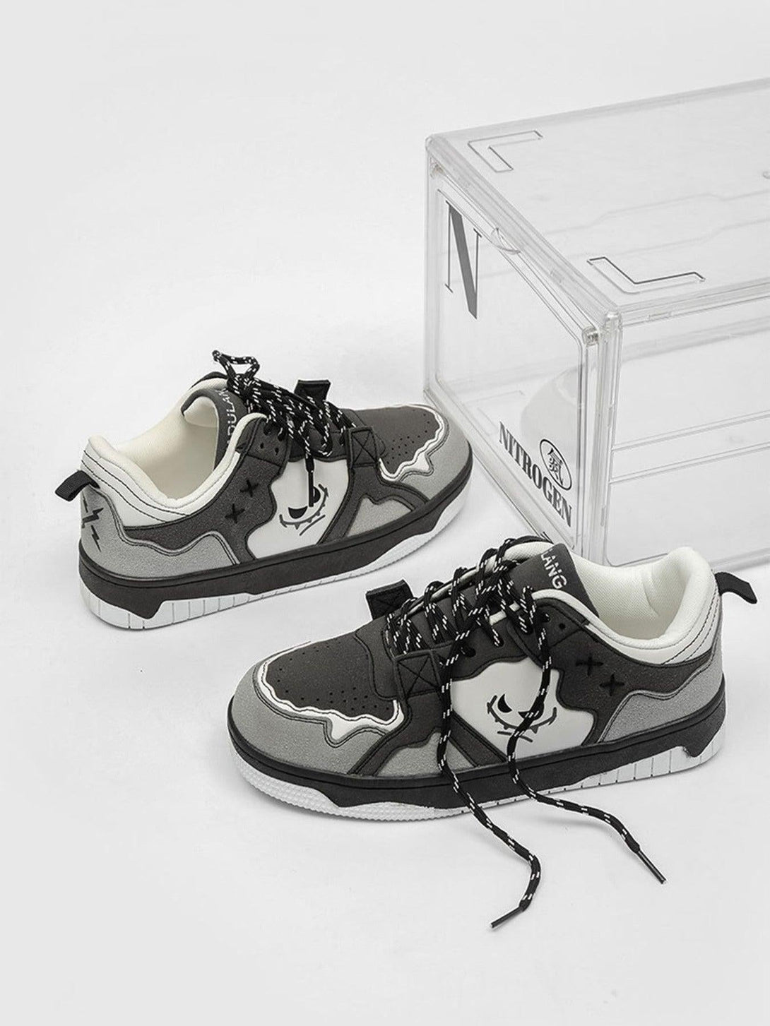 TALISHKO board shoes in gray with bold design details, next to a clear display box.