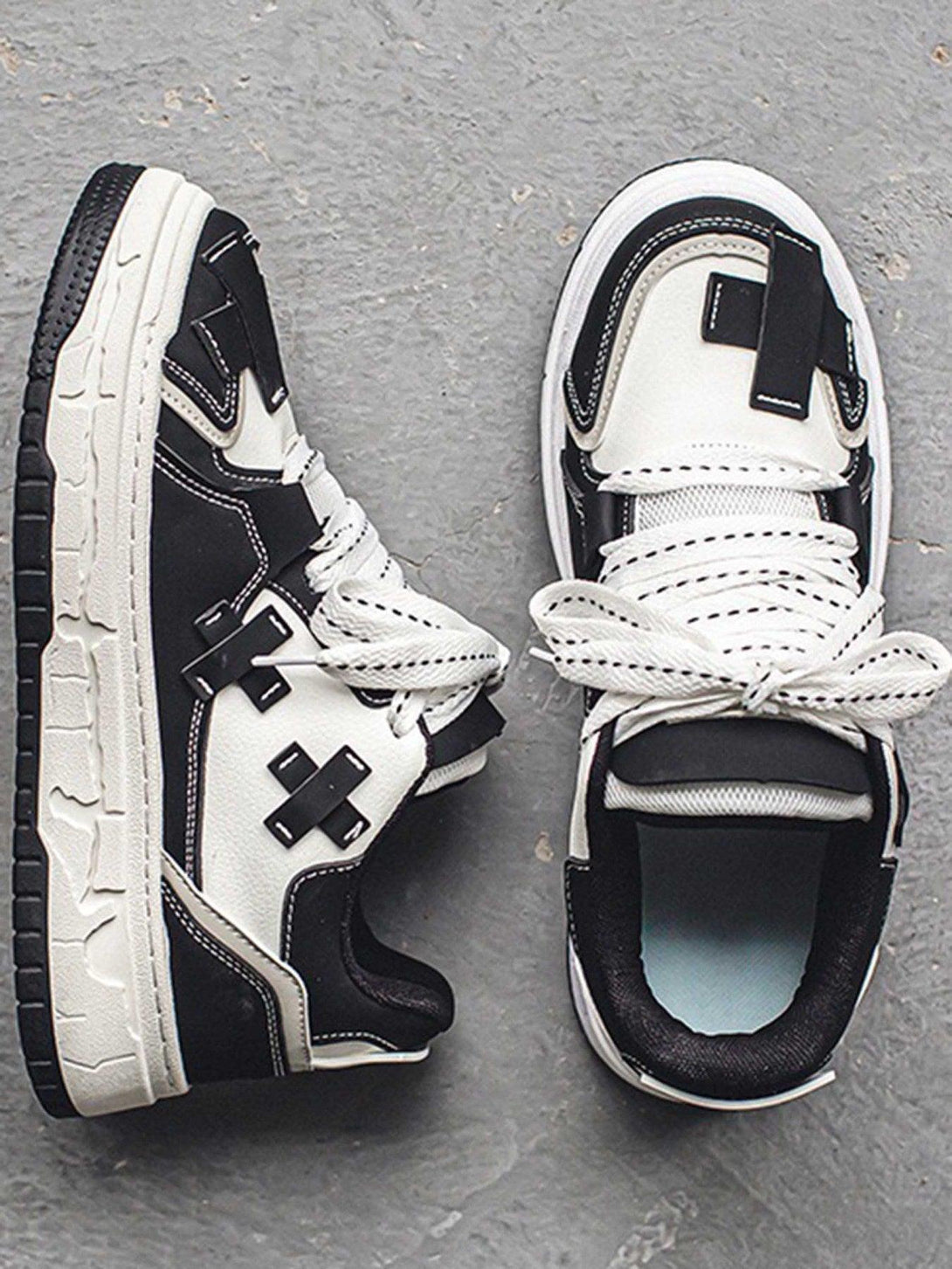 TALISHKO board shoes in black and white, showcasing a top-down view with stylish details.