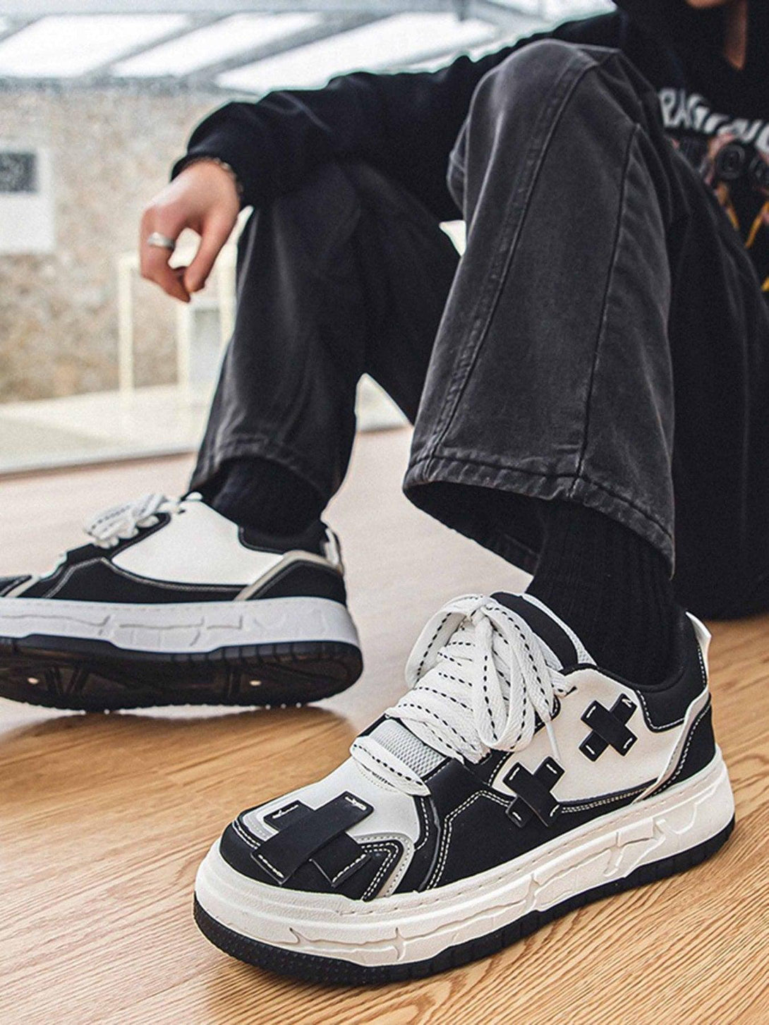 TALISHKO board shoes with bold black and white design, worn casually, highlighting urban style.