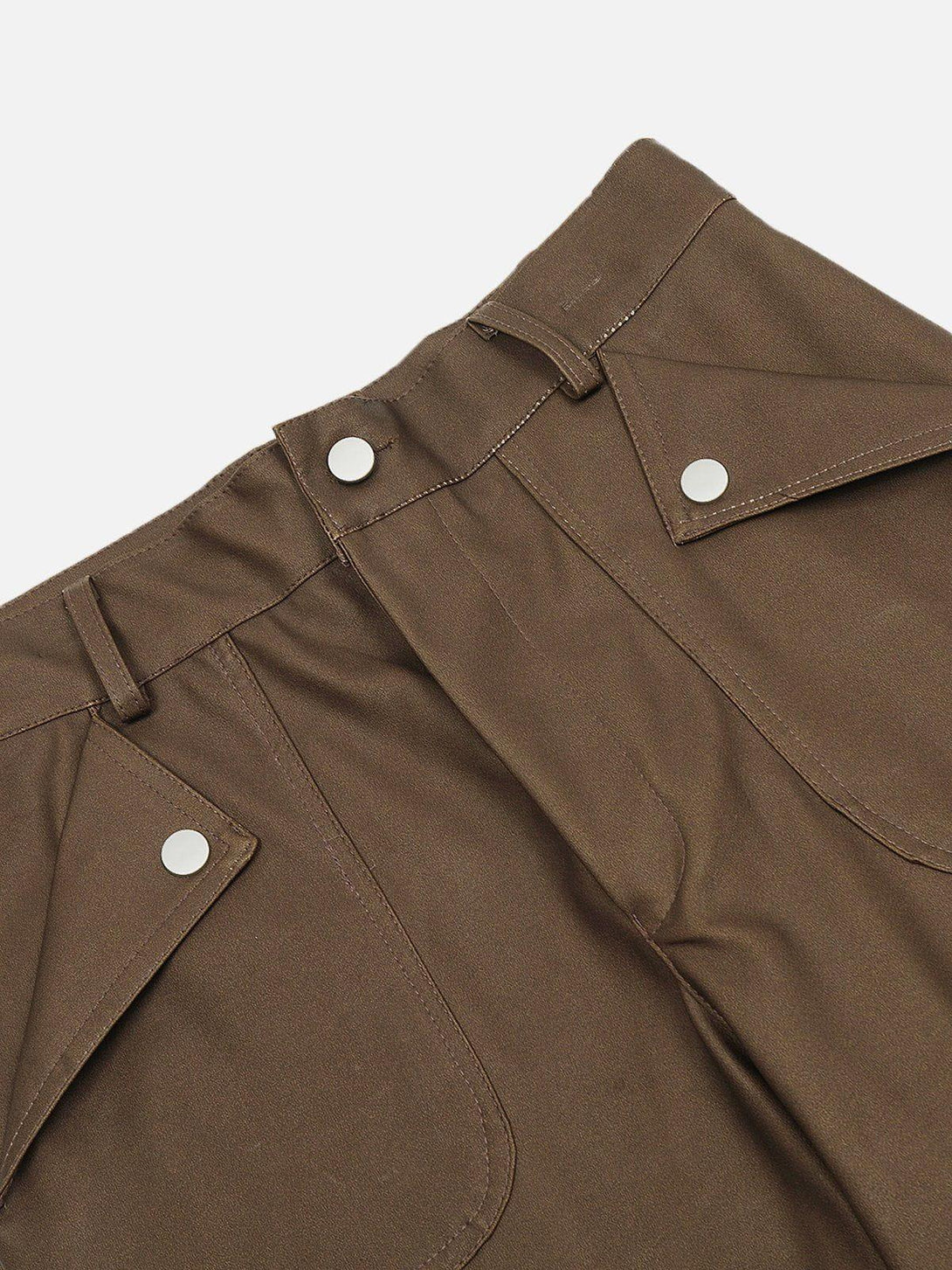 Zoomed-in view of brown faux leather cargo pants by TALISHKO, showing pocket details.