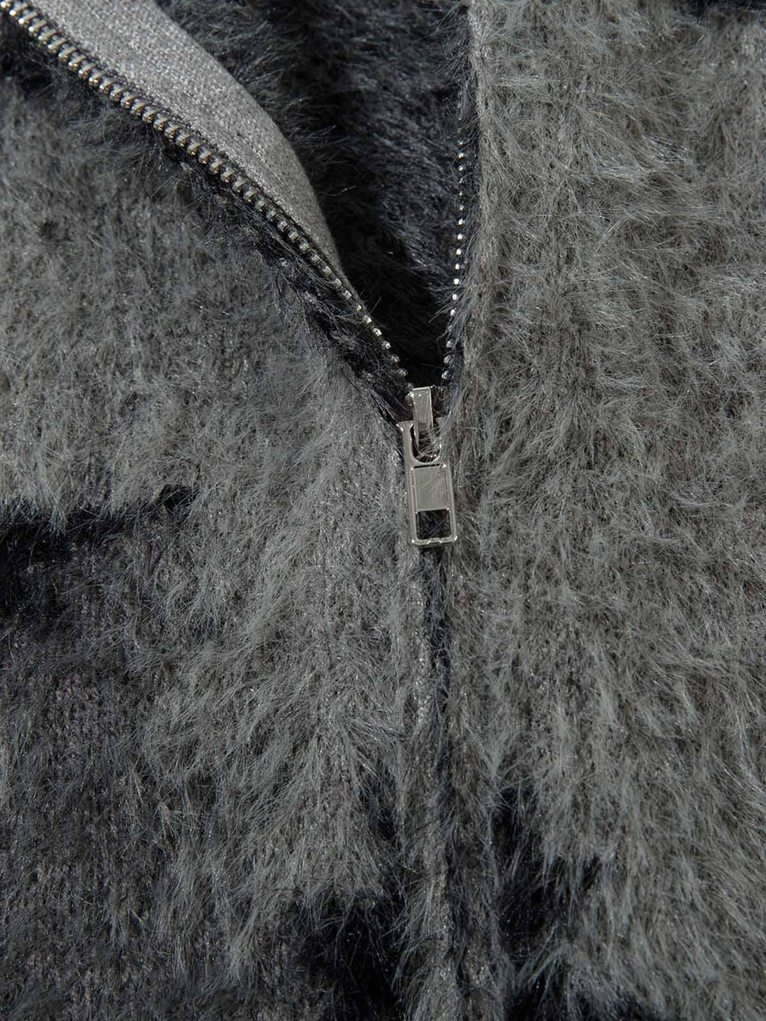 Detailed fabric and stitching of TALISHKO high-collar sweater, highlighting its fuzzy texture.