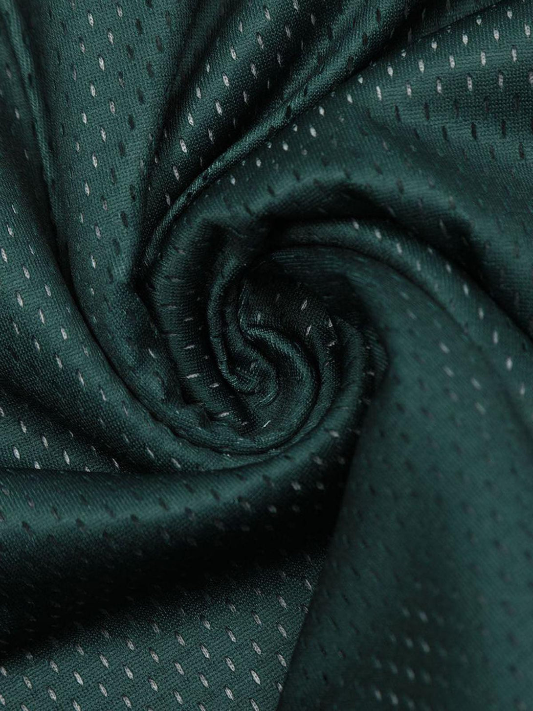 Intricate look at the textured dark green fabric by TALISHKO, showcasing subtle patterned details.