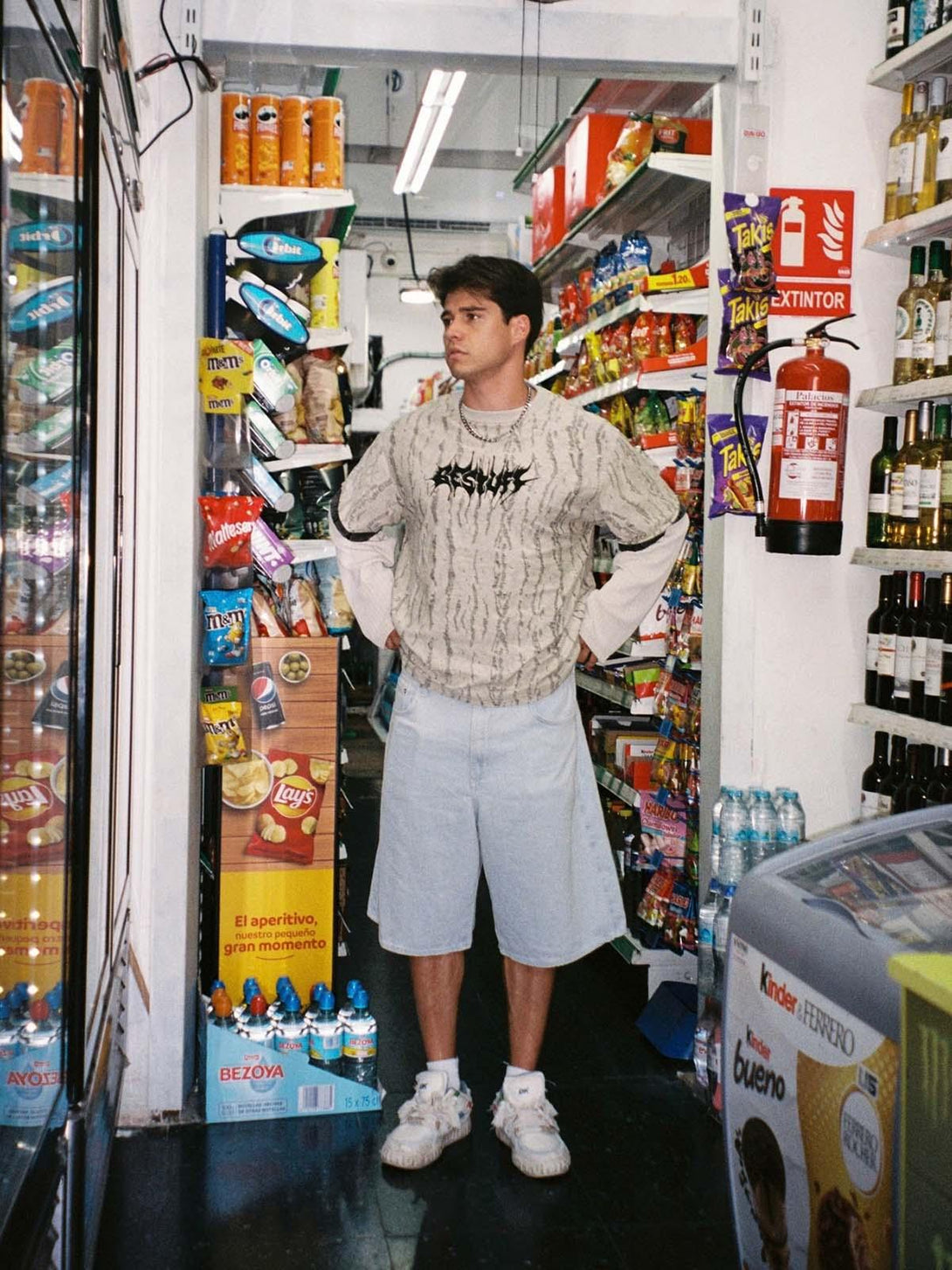 Model exploring store in TALISHKO's faux two-piece distressed T-shirt with a layered look.