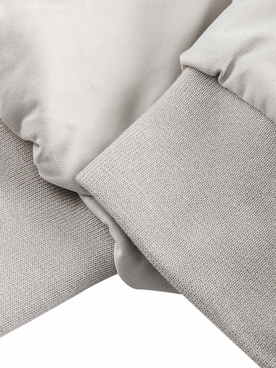 Detailed fabric and stitching of TALISHKO's bomber jacket, showcasing cuff and sleeve texture.