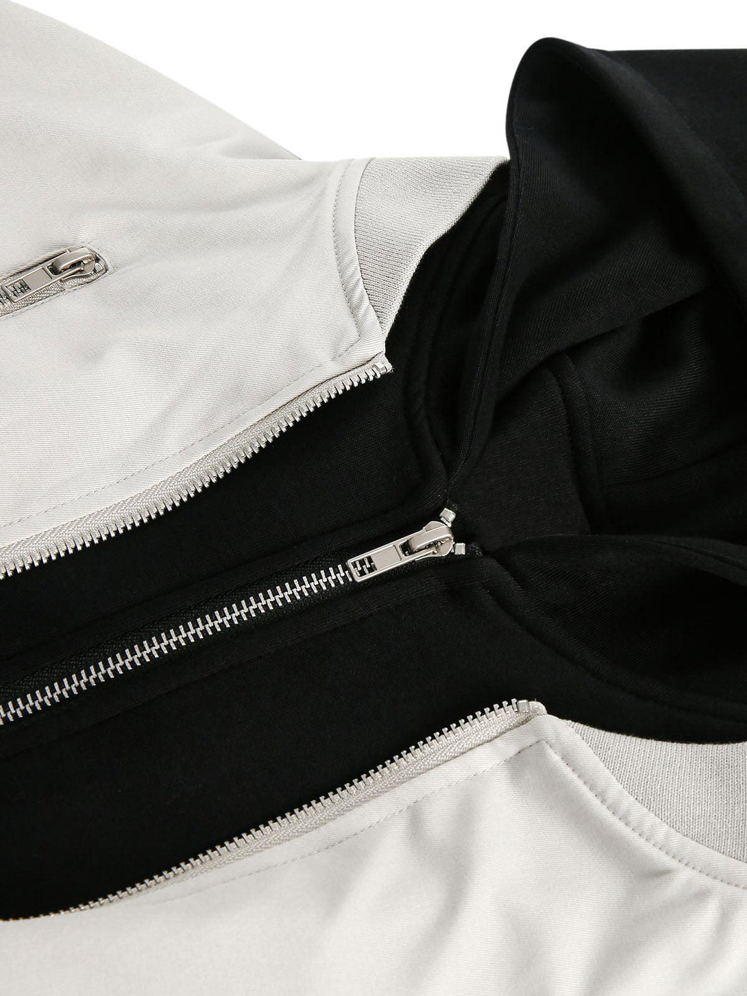 Detailed look at TALISHKO's spliced bomber jacket, highlighting zippers and contrasting fabrics.