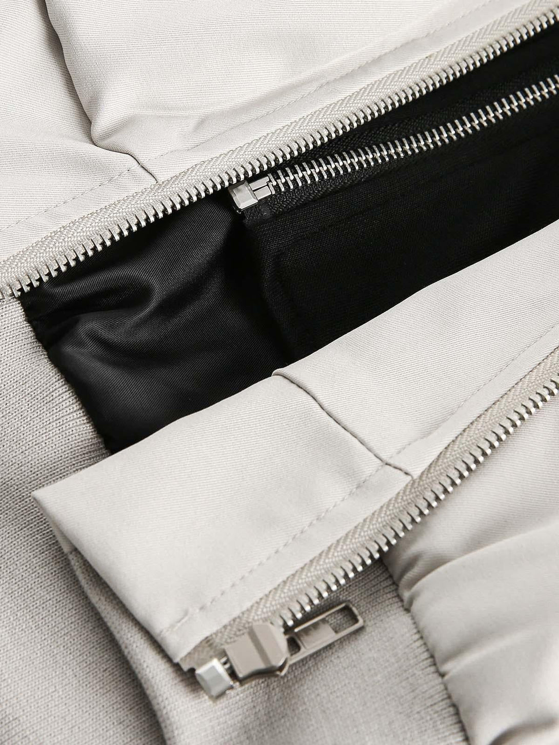 Focusing on TALISHKO's bomber jacket, highlighting the zipper and pocket detailing.