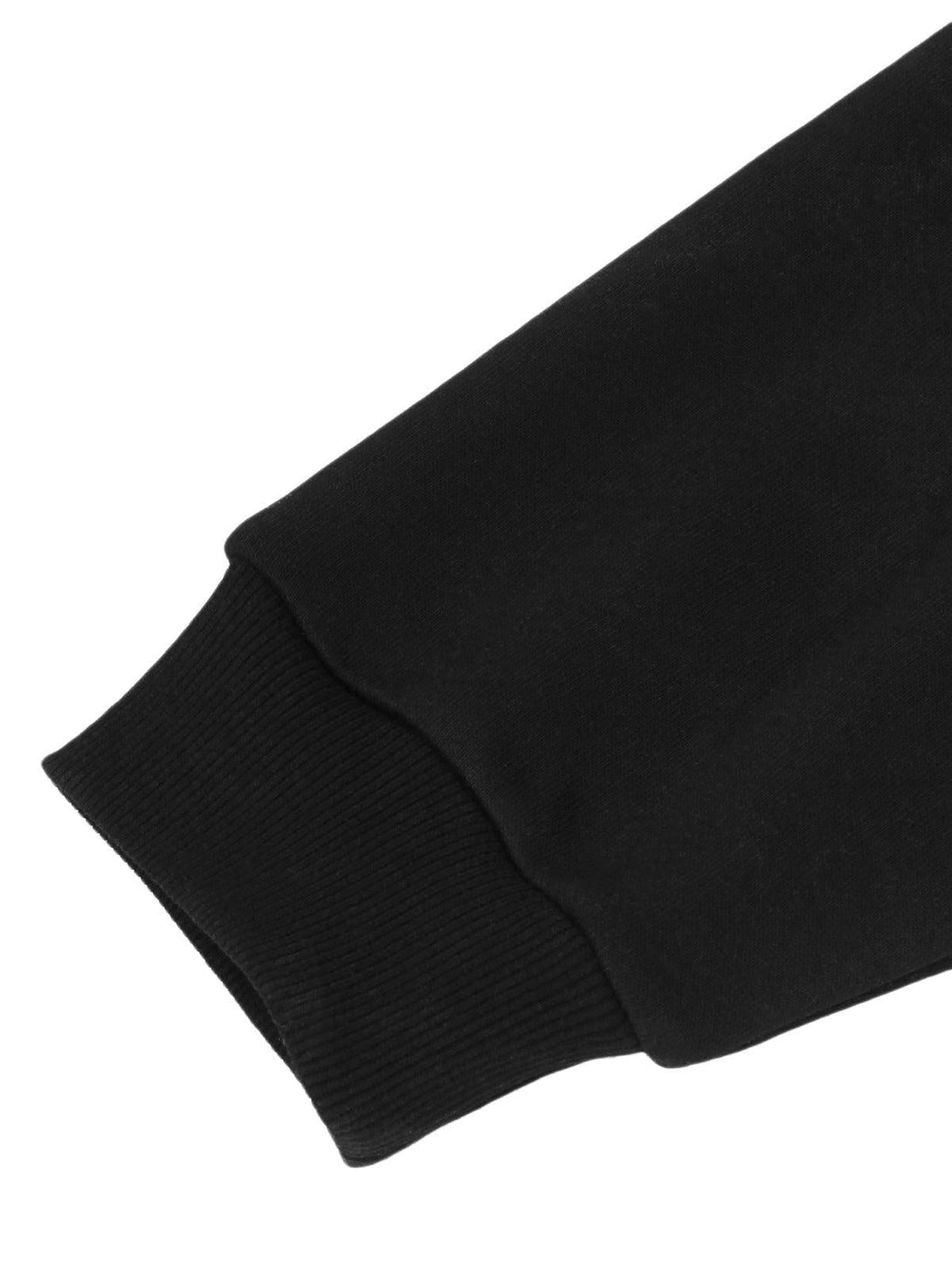 A close-up of TALISHKO's black sleeve cuff, highlighting the ribbed knit texture and design.