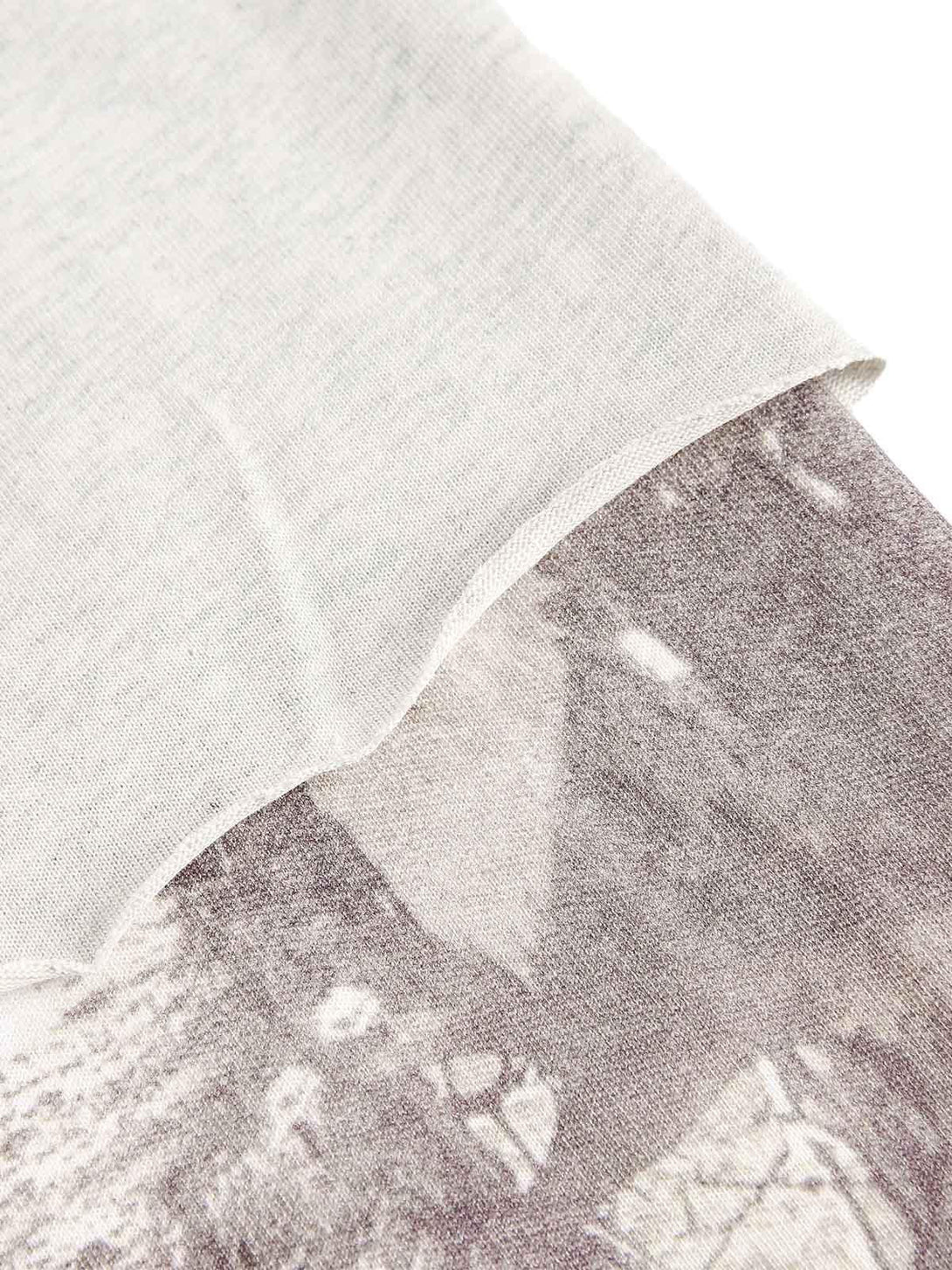 A close-up of TALISHKO's faux two-piece T-shirt, highlighting the fabric texture and print.