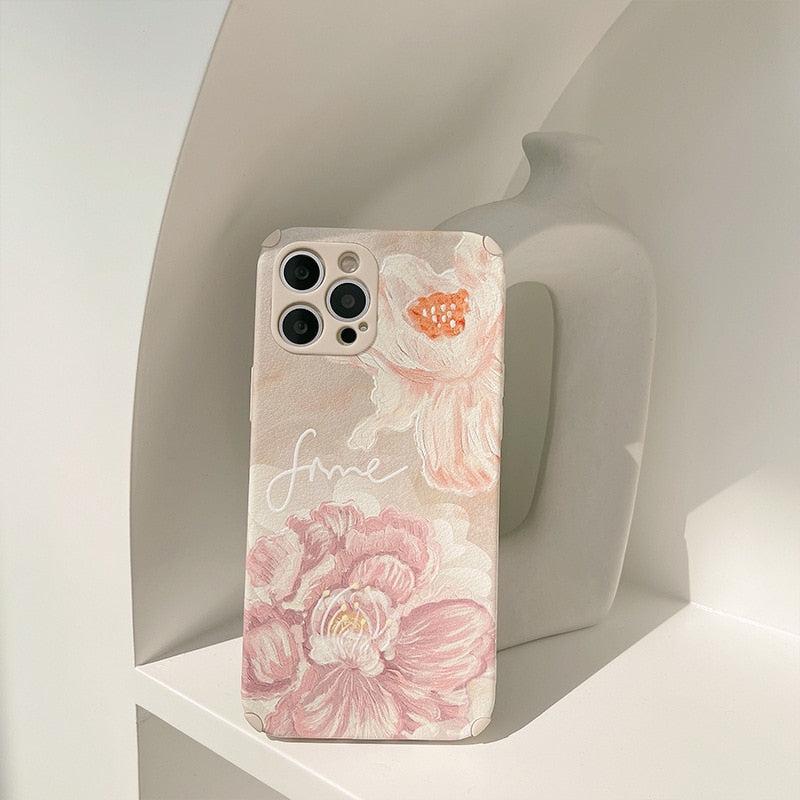 A delicate floral iPhone case by TALISHKO, featuring intricate pink and peach flower designs.