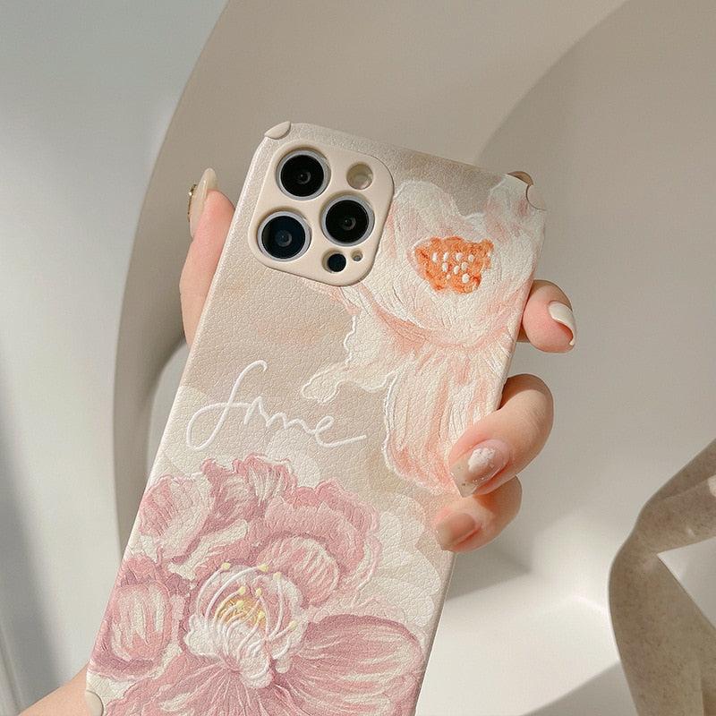 TALISHKO iPhone case adorned with delicate floral prints, showcasing intricate pink and peach flowers.