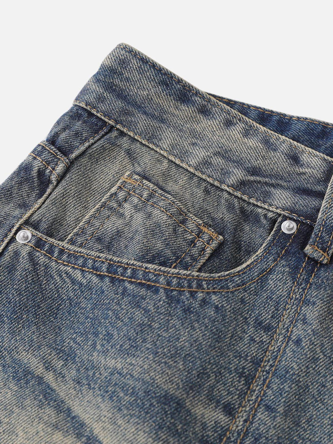Intricate look at TALISHKO jeans pocket, highlighting detailed stitching and distressed denim.