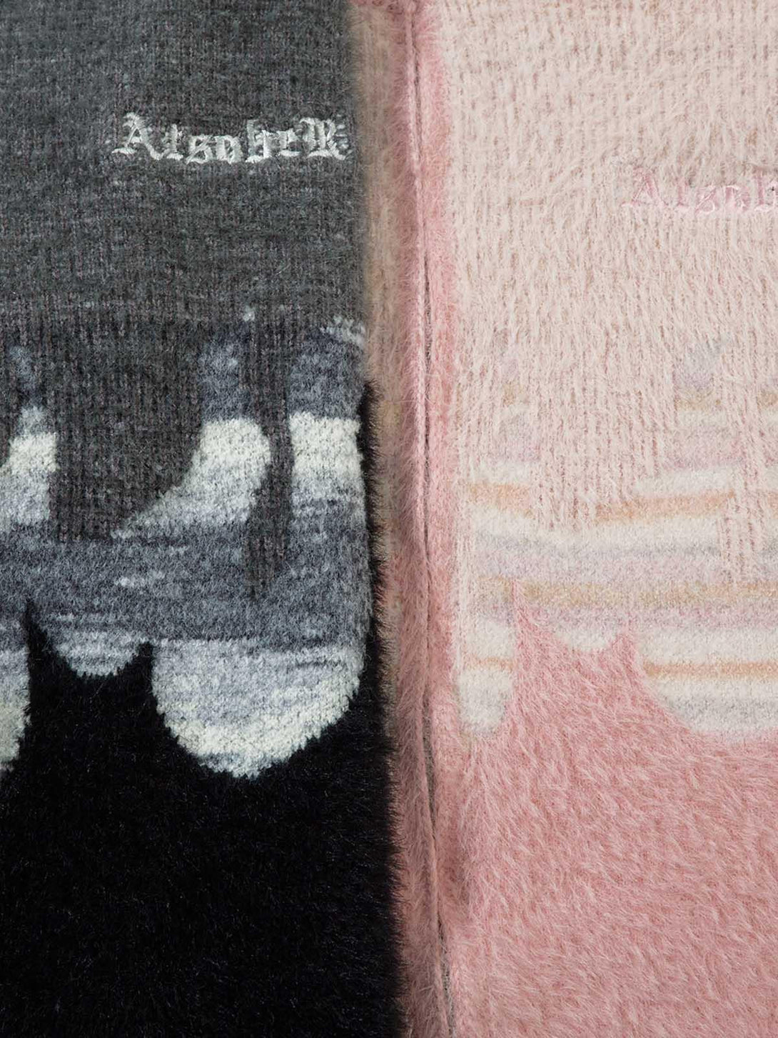 A detailed view of the fuzzy texture and flame design on TALISHKO's zipper sweater.