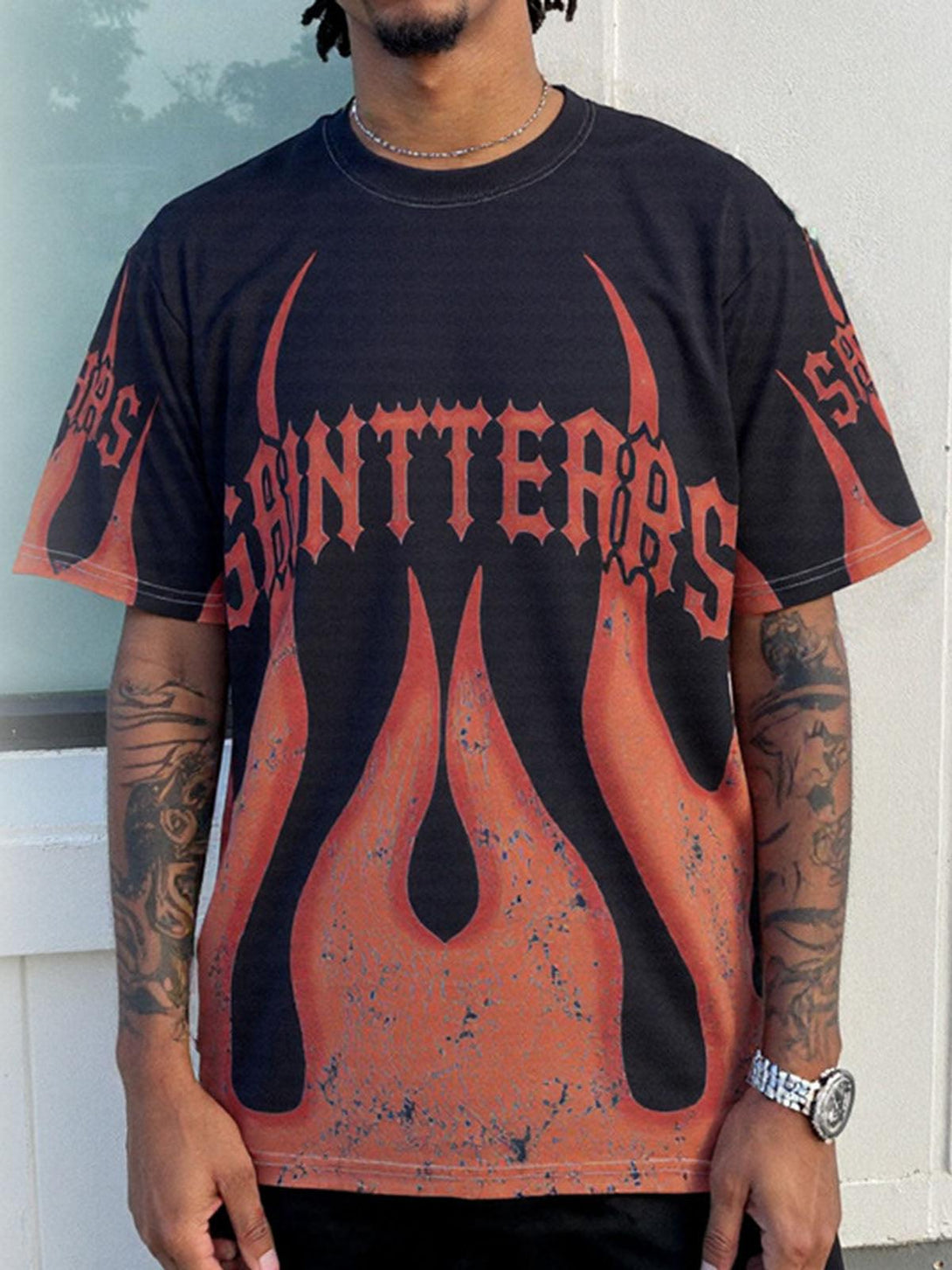 Model wearing a striking flame graphic crew neck T-shirt by TALISHKO, great for casual looks.