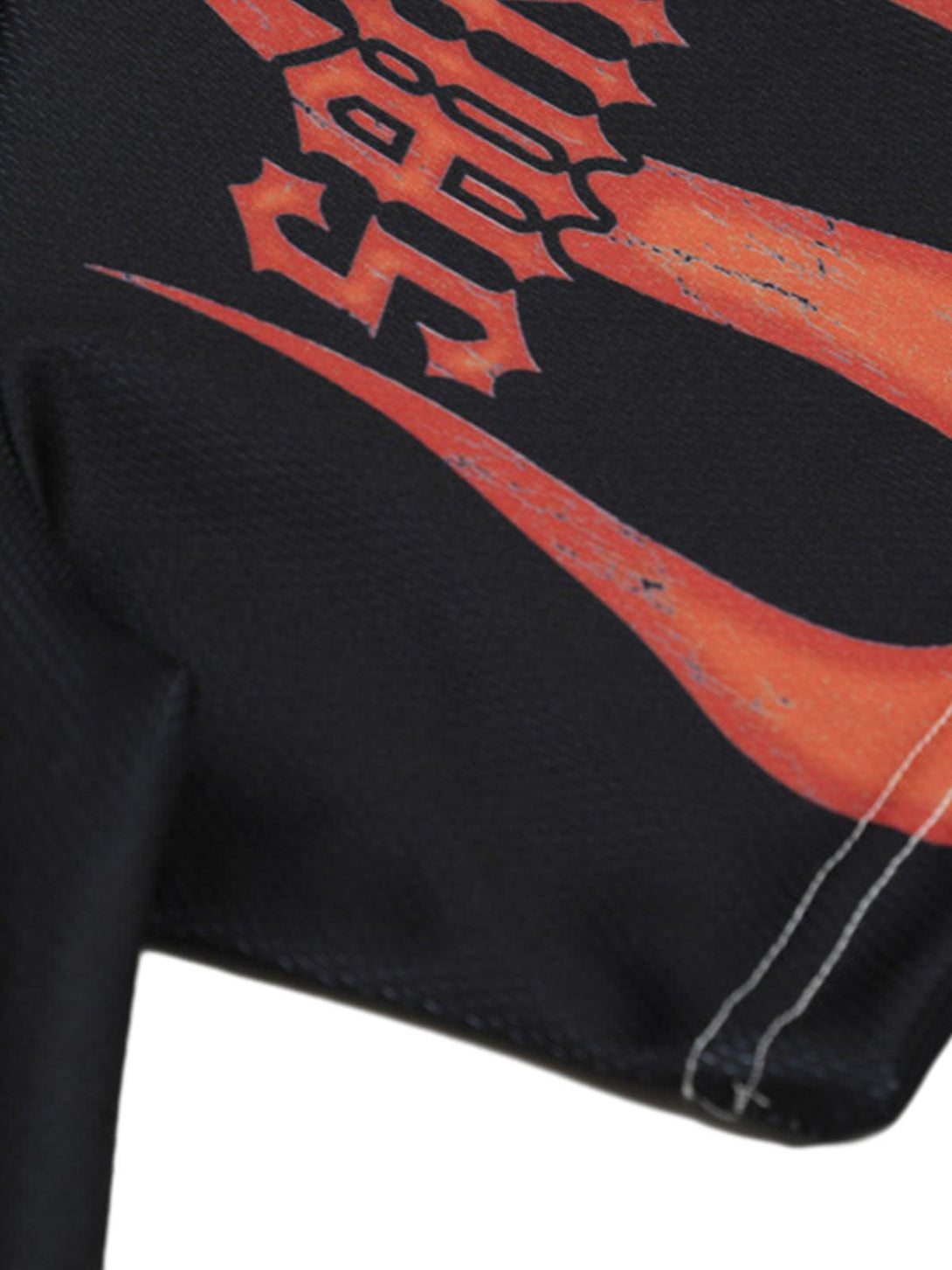 A detailed view of the flame pattern on a TALISHKO crew neck T-shirt, showcasing bold design.