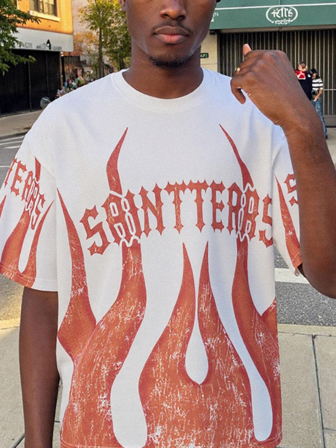 Model wearing a bold flame graphic crew neck t-shirt by TALISHKO, ideal for casual outings.