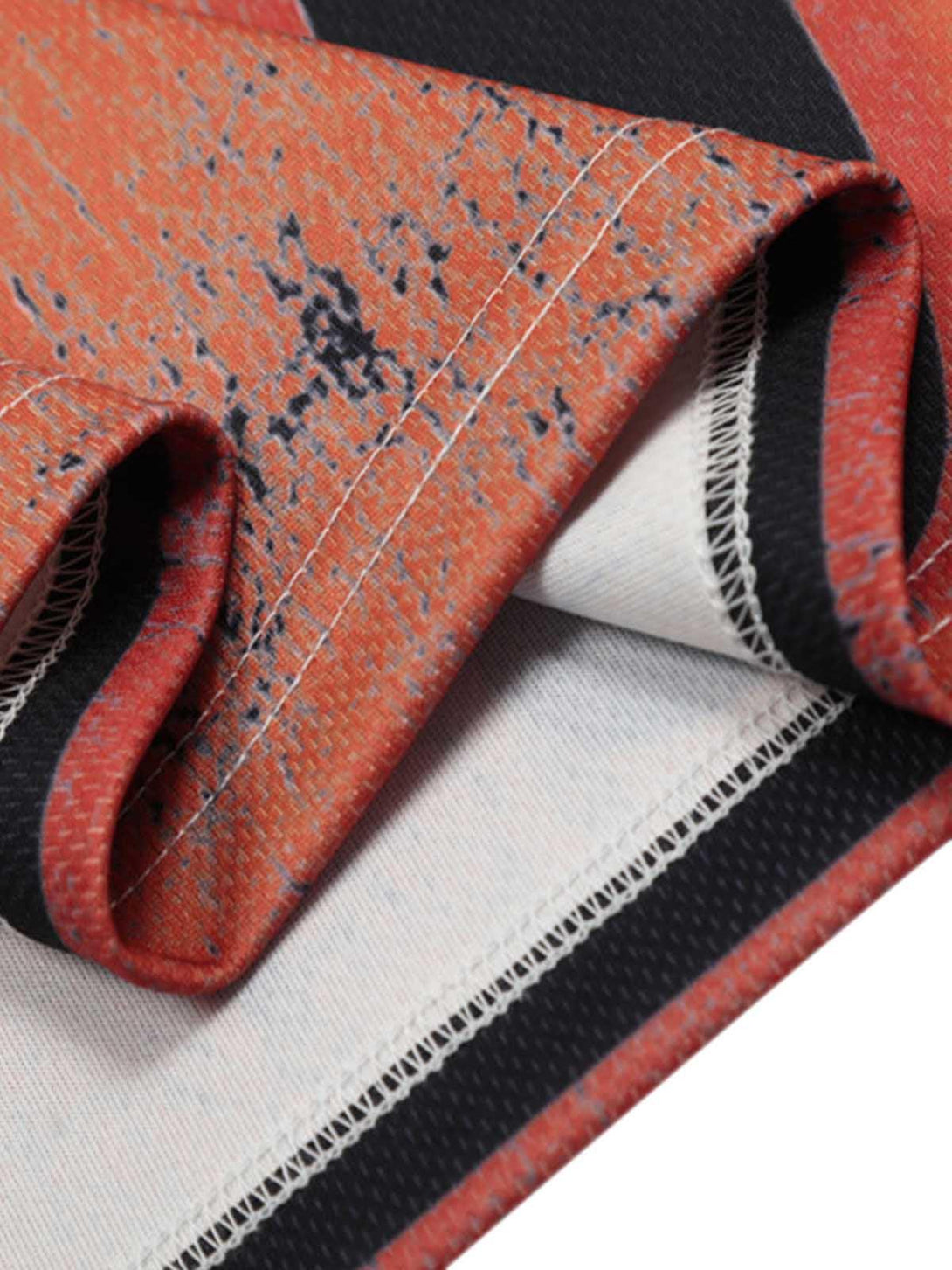 Intricate look at the flame pattern and stitching on a TALISHKO crew neck T-shirt, perfect for a bold style.