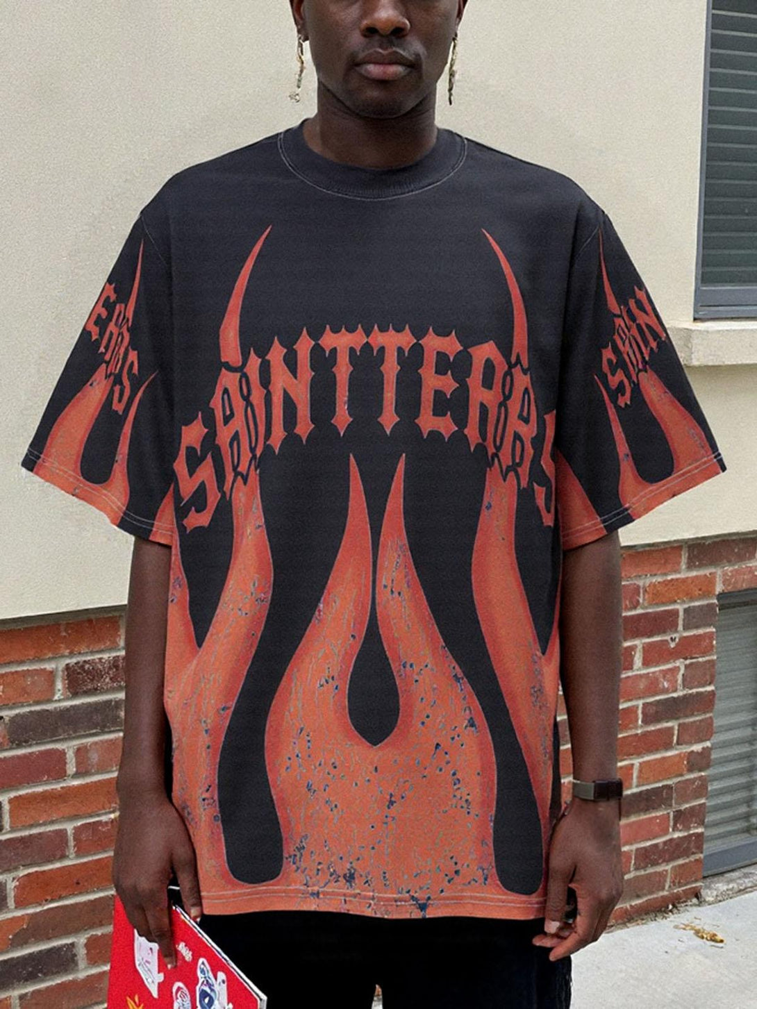 Model wearing TALISHKO flame graphic t-shirt with striking design, ideal for casual flair.