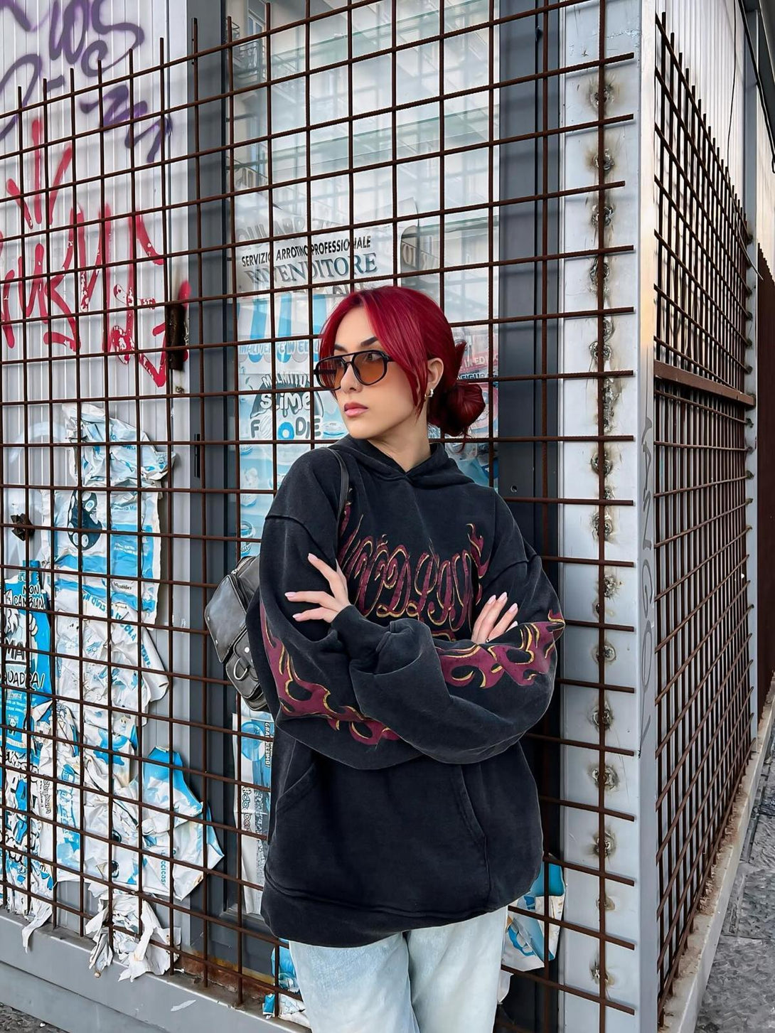 A stylish TALISHKO hoodie with flame detailing, worn by model for a trendy streetwear look.