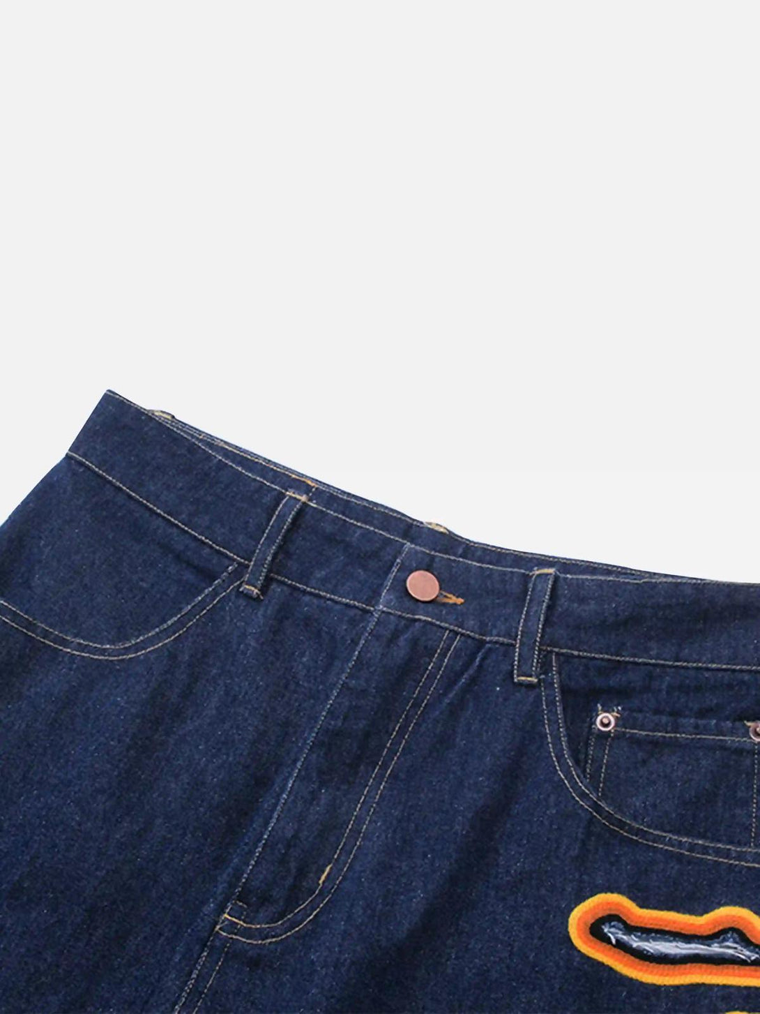 TALISHKO's denim jeans showcasing flame-scarred embroidery with vibrant orange details.