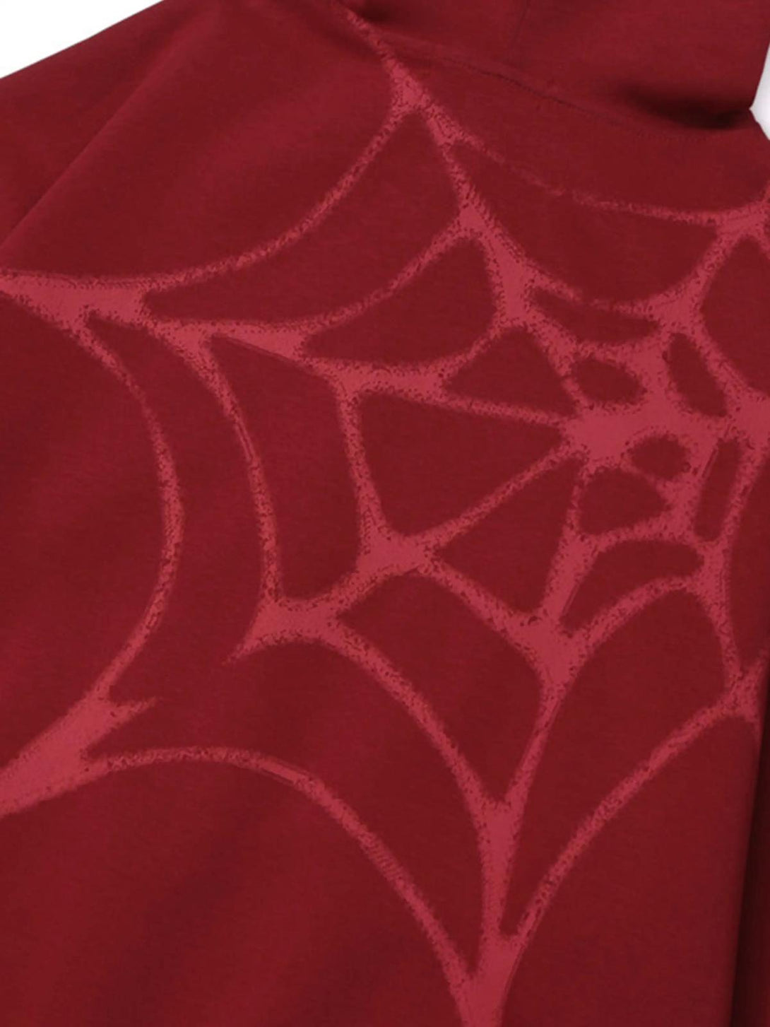 A close-up of the TALISHKO hoodie showcasing a subtle red spider web pattern on rich fabric.