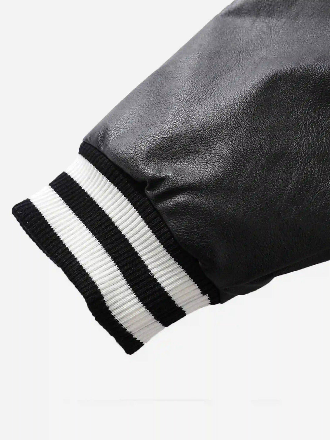 TALISHKO's baseball jacket sleeve, featuring a black and white striped cuff detail.