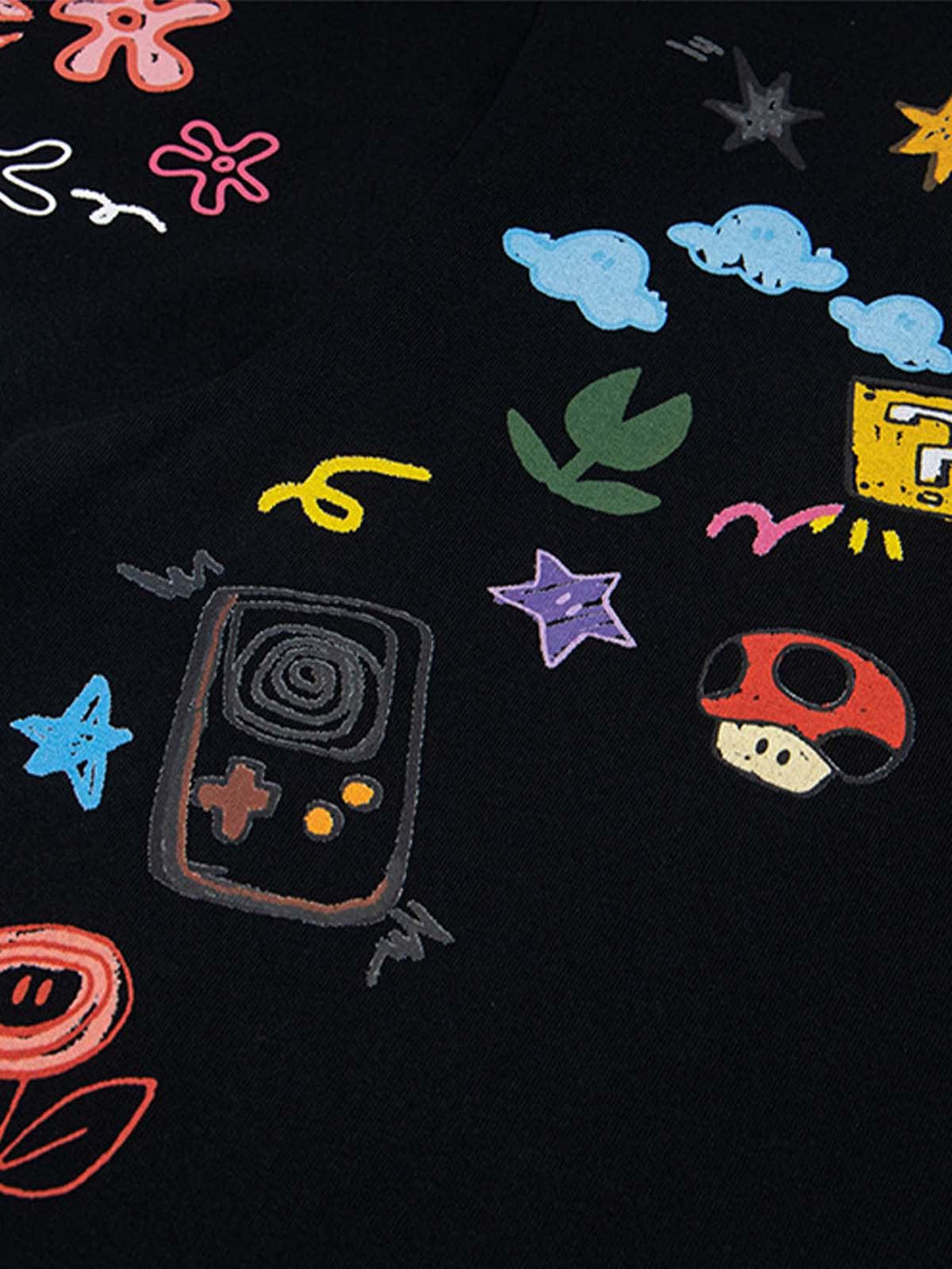 Playful embroidery on black TALISHKO T-shirt featuring colorful graphics, highlighting creativity.