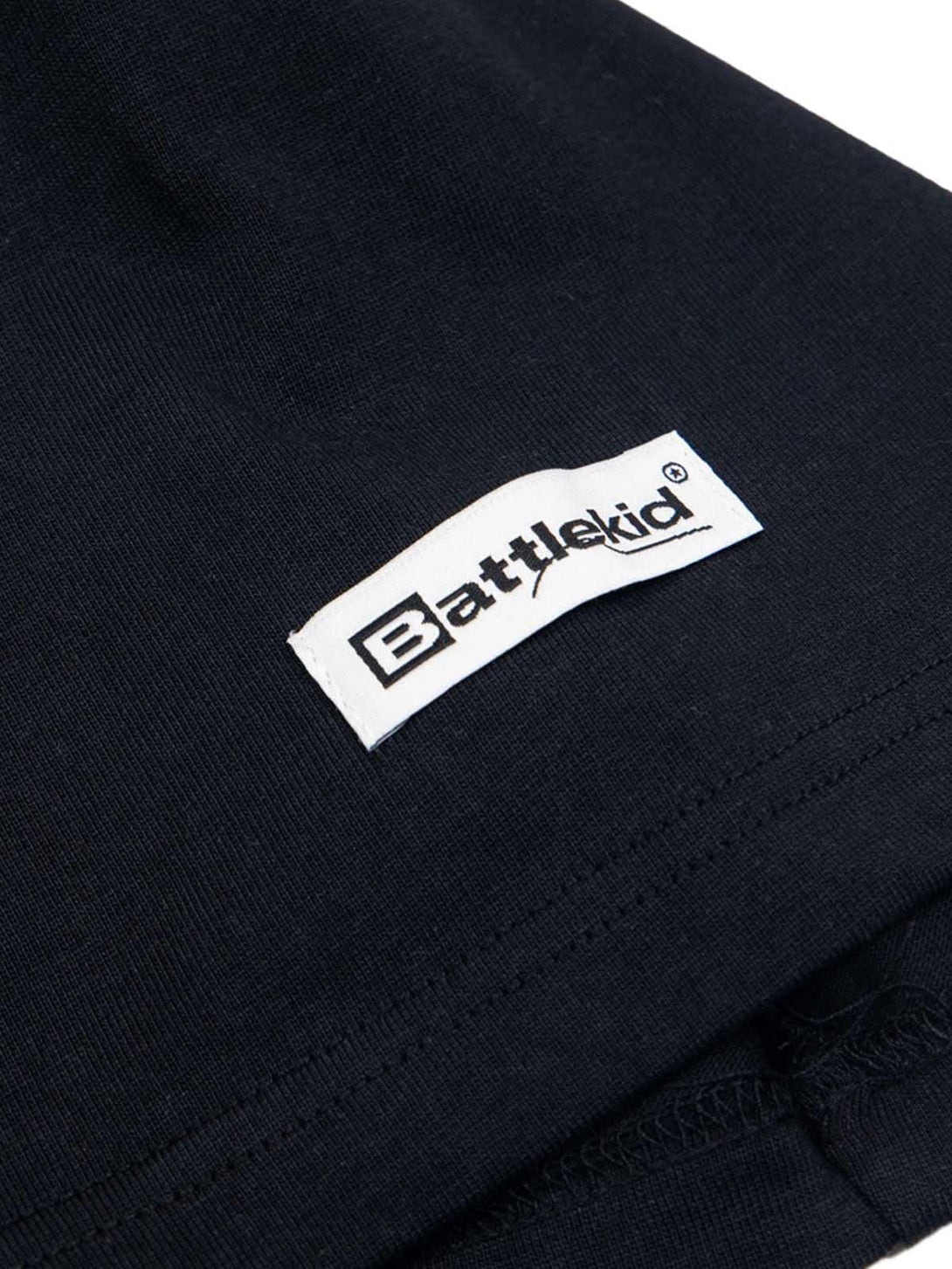 Zoomed-in view of the Battlekid label on a black t-shirt by TALISHKO.