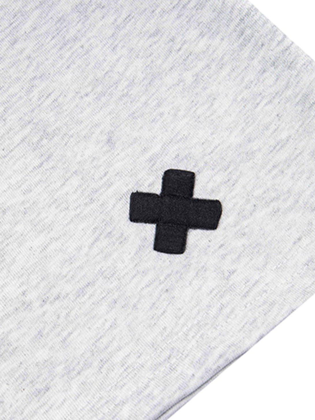 Detailed fabric and stitching of TALISHKO T-shirt with a black cross design on light gray fabric.